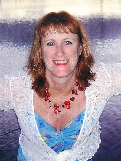 Cushla, a vibrant 41 year old woman smiling into the camera.