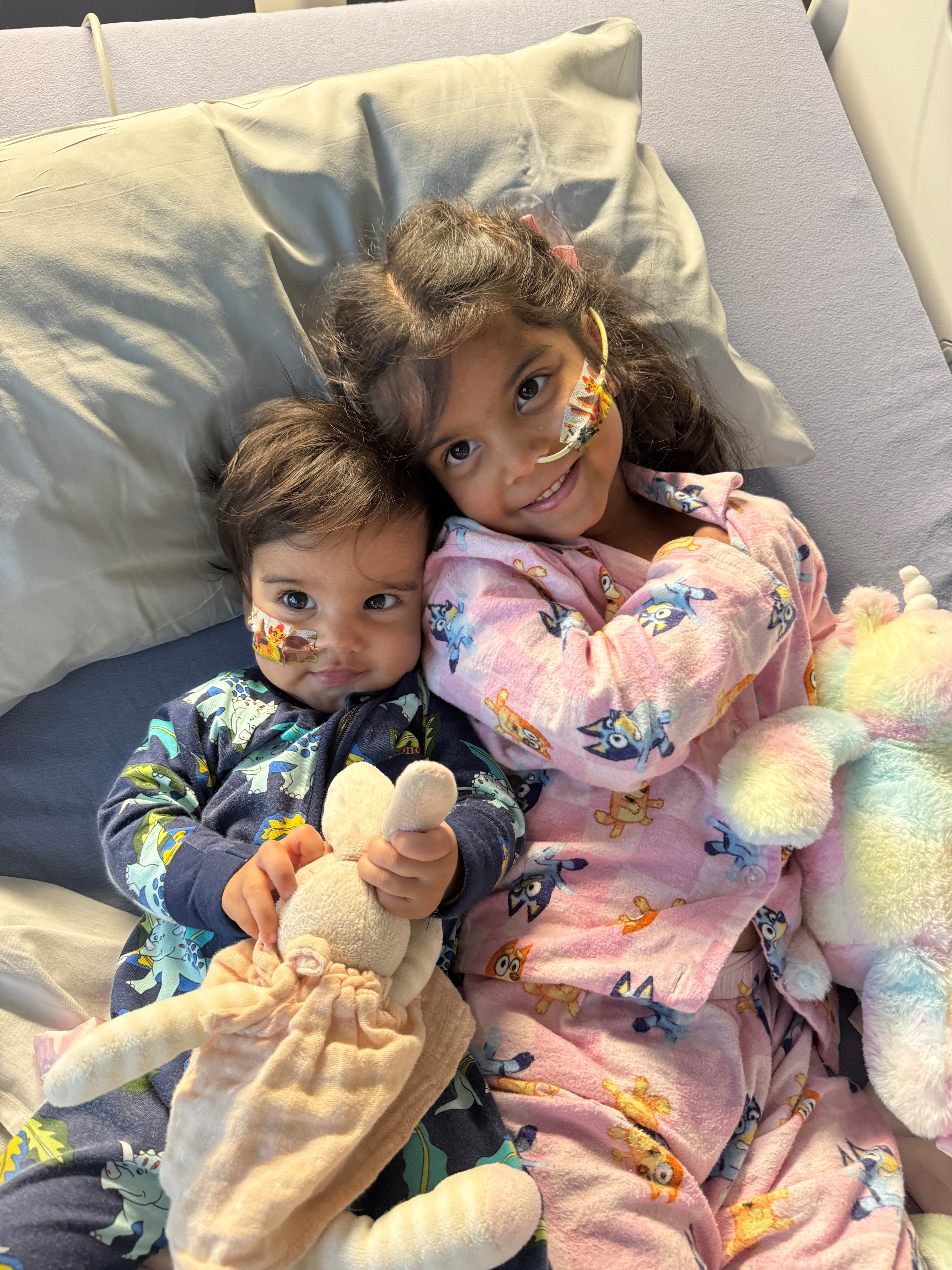 Zeke and Zara, both with nasogastric tubes share a hospital bed