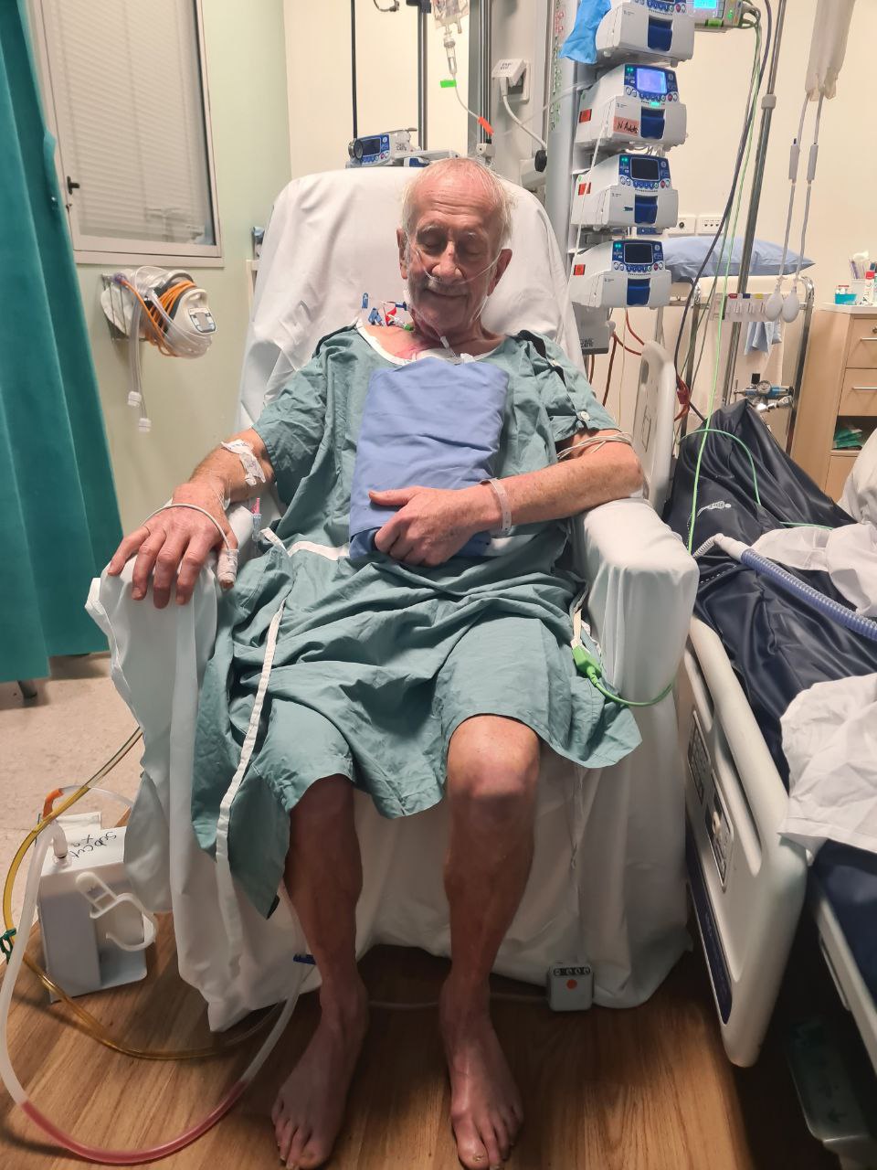 Joe, and elderly man sits in an ICU chair attached to monitors.