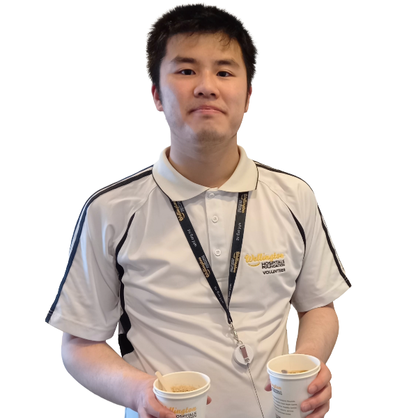 Jonathon, an ED volunteer holding cups of tea.