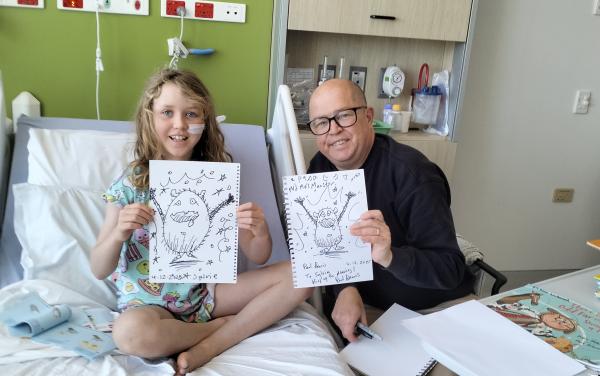 Paul Beavis and a young patient share their drawings.