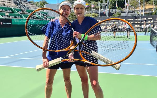 pair holding jumbo tennis rackets