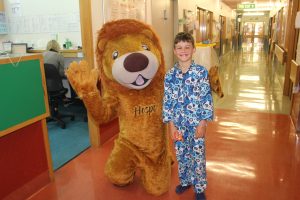 Wellington Children’s Hospital mascot Hospi, with patient Austen and his new pair of warm pyjamas.