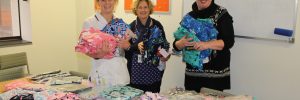 Wellington Regional Children's Hospital Clinical Nurse Specialist Charlotte Stanczuk, with Paediatric Community Nurses Kerry Dellabarca and Helen Orr and some of the pyjamas.