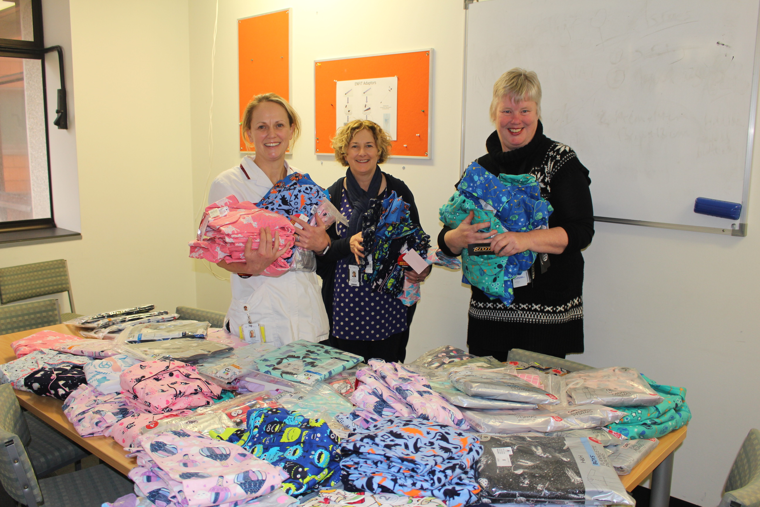 Wellington Regional Children's Hospital Clinical Nurse Specialist Charlotte Stanczuk, with Paediatric Community Nurses Kerry Dellabarca and Helen Orr and some of the pyjamas.