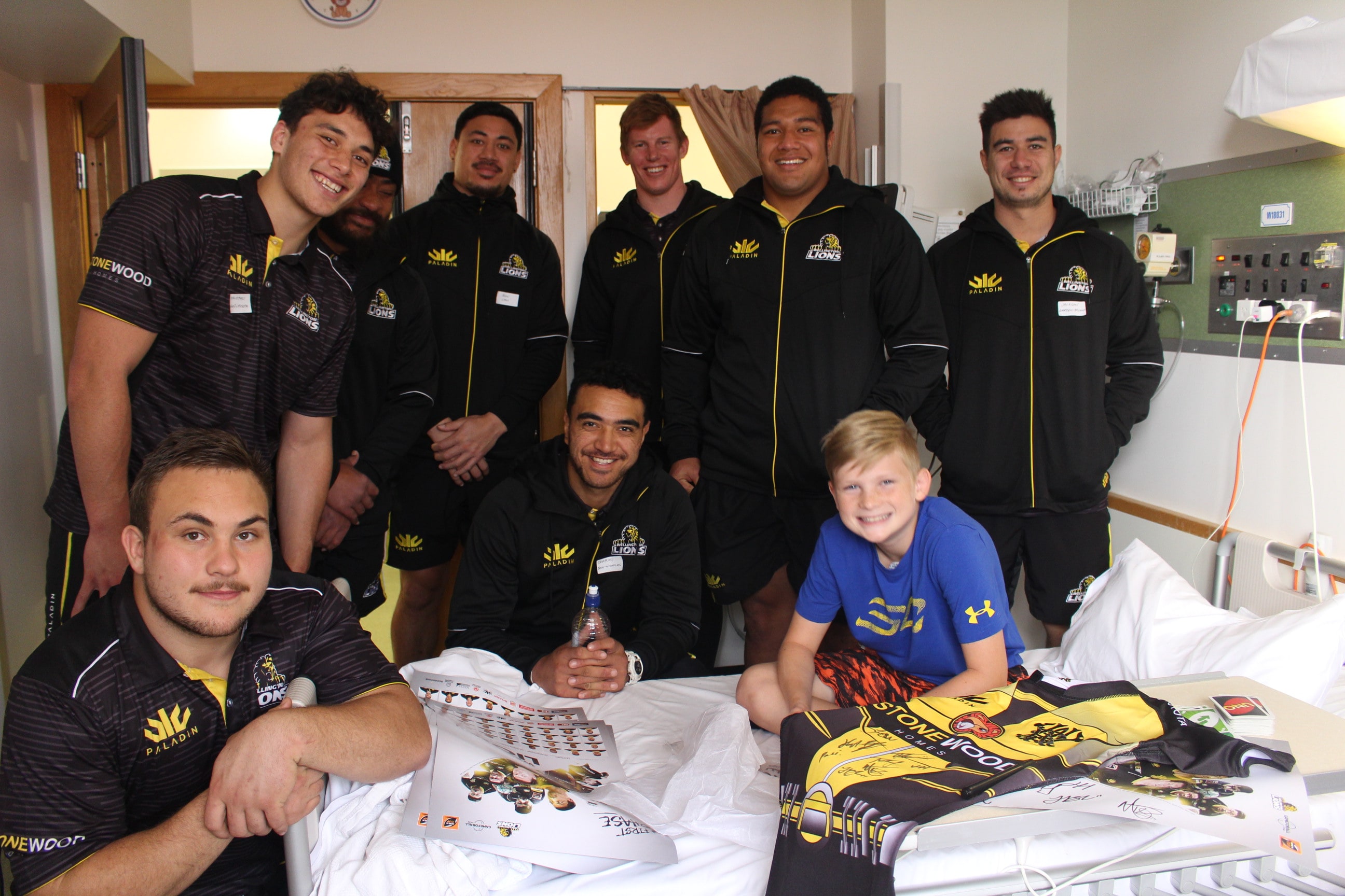 Wellington Children's Hospital patient with some of the Wellington Lions rugby team.