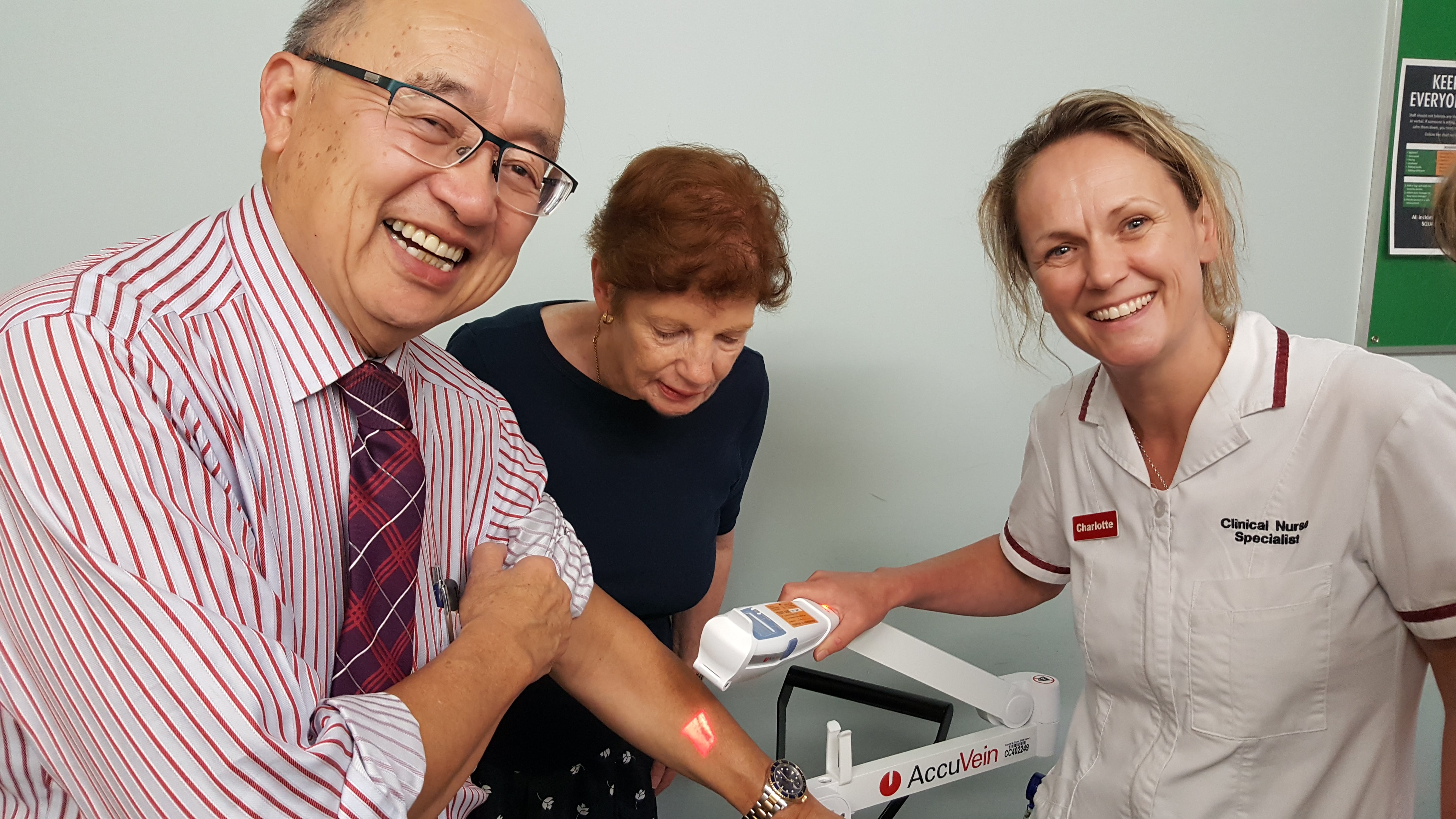 Charlotte Stanczuk (Clinical Nurse Specialist, Wellington Regional Children’s Hospital) shows Mark Chiu and Patricia Cooper (Rotary Club of Mt Victoria members) how the AccuVien Device works.